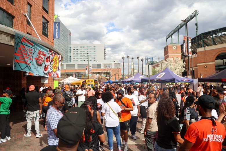 Fans gather outside of the baseball stadium