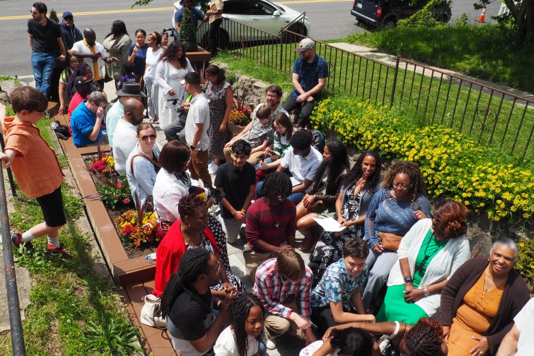 Community members gather and awaits the opening ceremony of The Alley at The Urban Oasis.