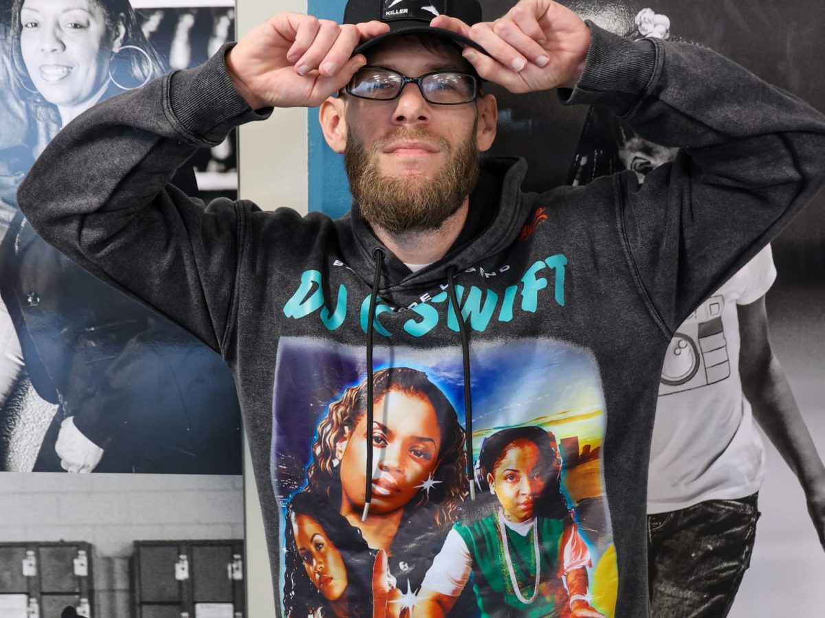 A person poses in a k-swift hoodie at the black artists fair club music day celebration