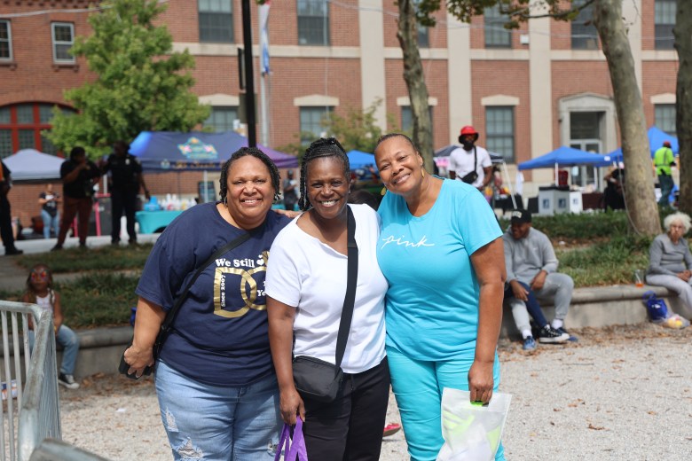 Three people smile for the camera