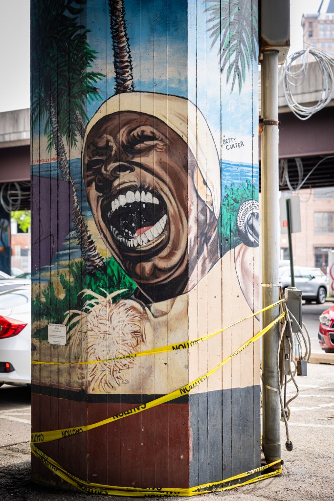 A restored mural on a pillar, originally painted by artist Pontella Mason, of jazz artist Betty Carter.