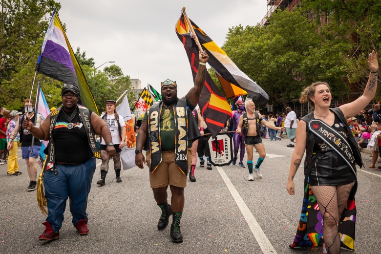 Chris Jay, 2025 winner of Maryland Leather contest, and Lord Thunderknight, winner of the World Bear competition, walk with members of the COMMAND MC Baltimore Leather club.