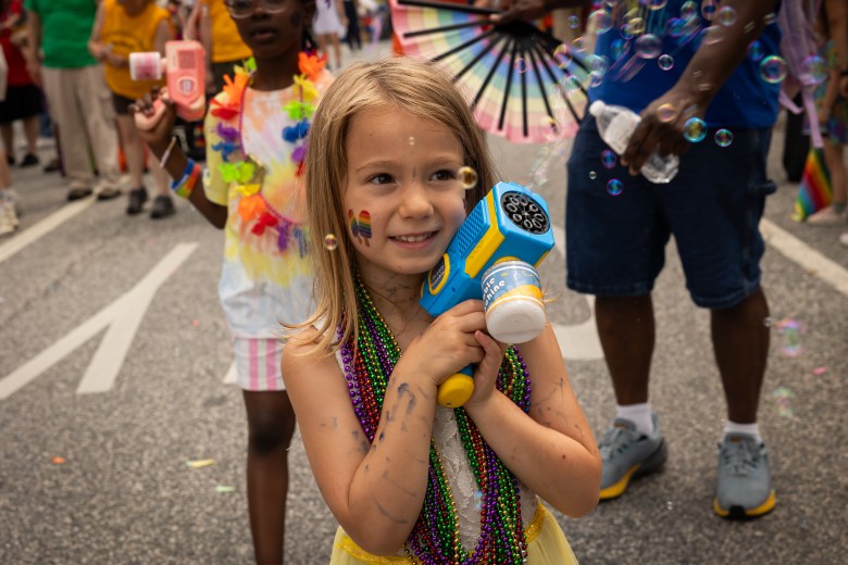 Children with bubble shooters walking with various religious groups as part of Faith Communities of Baltimore.