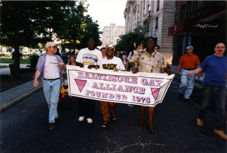  A group of men walks with a banner for the Baltimore Gay Alliance at the Baltimore Pride Parade. From a series of images of the 2000 Baltimore Pride Parade by the photographer Joseph Kohl.