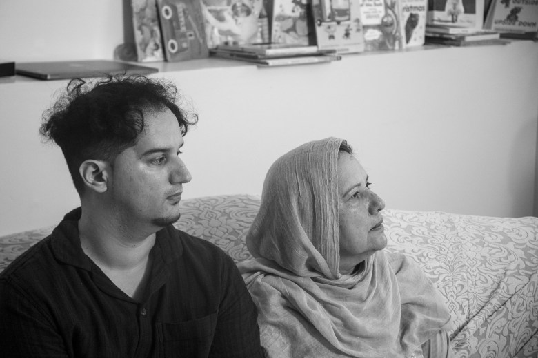 Syed's younger brother and mother watch him speak.