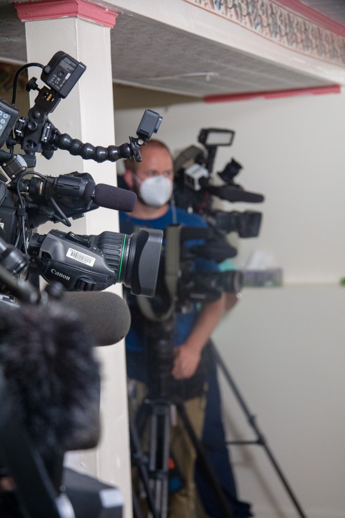 Local journalists and news cameras