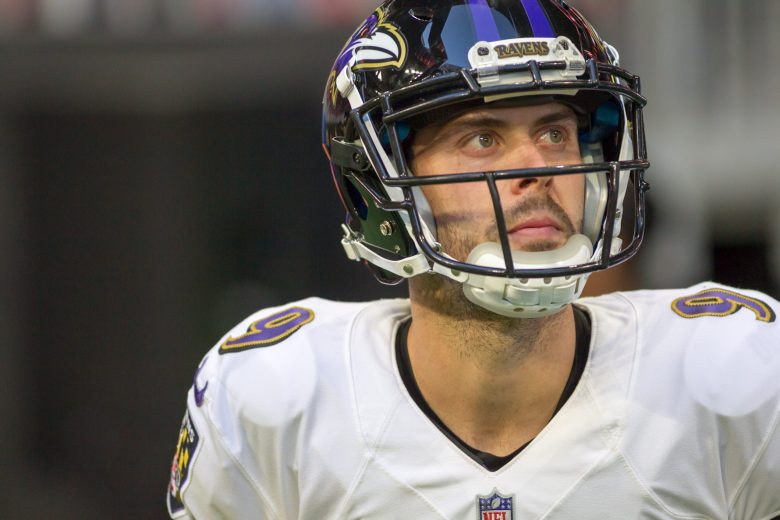 A photo of a man wearing a Baltimore Ravens football team uniform.
