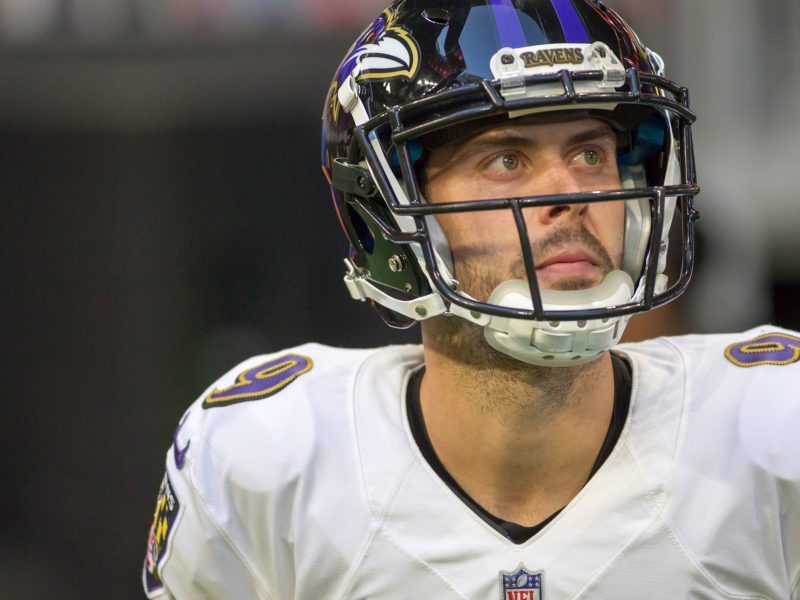 A photo of a man wearing a Baltimore Ravens football team uniform.
