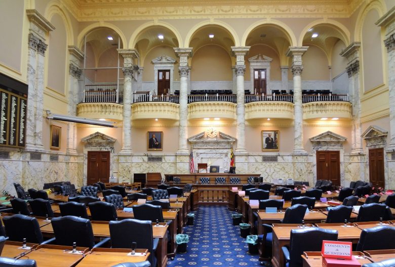 This image depicts rows of chairs and desks inside the Senate Chamber in Annapolis, Md.