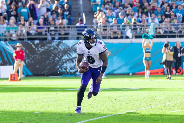 Ravens player Lamar Jackson runs on a football field.