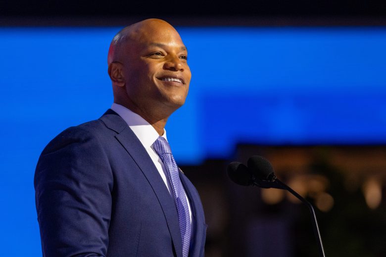 Color photo of Governor Wes Moore, he has brown skin and is wearing a blue suit.