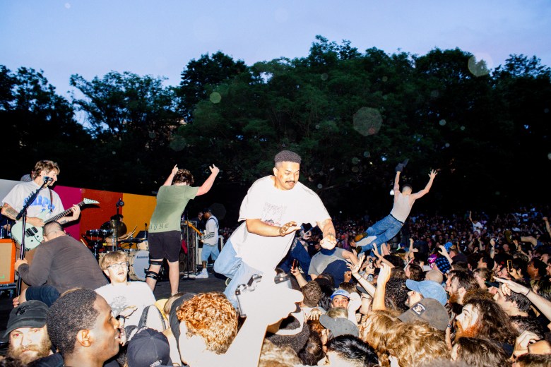Members of the audience throw themselves into the mosh pit.